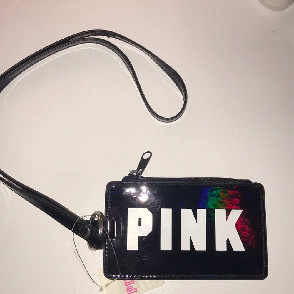 Pink lanyard with ID window and zipper closure.
